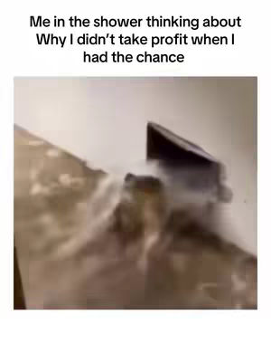 The image shows a blurry, poorly lit scene of a shower. Water appears to be running, and the background is indistinct. Text overlayed on the image reads, "Me in the shower thinking about Why I didn't take profit when I had the chance."