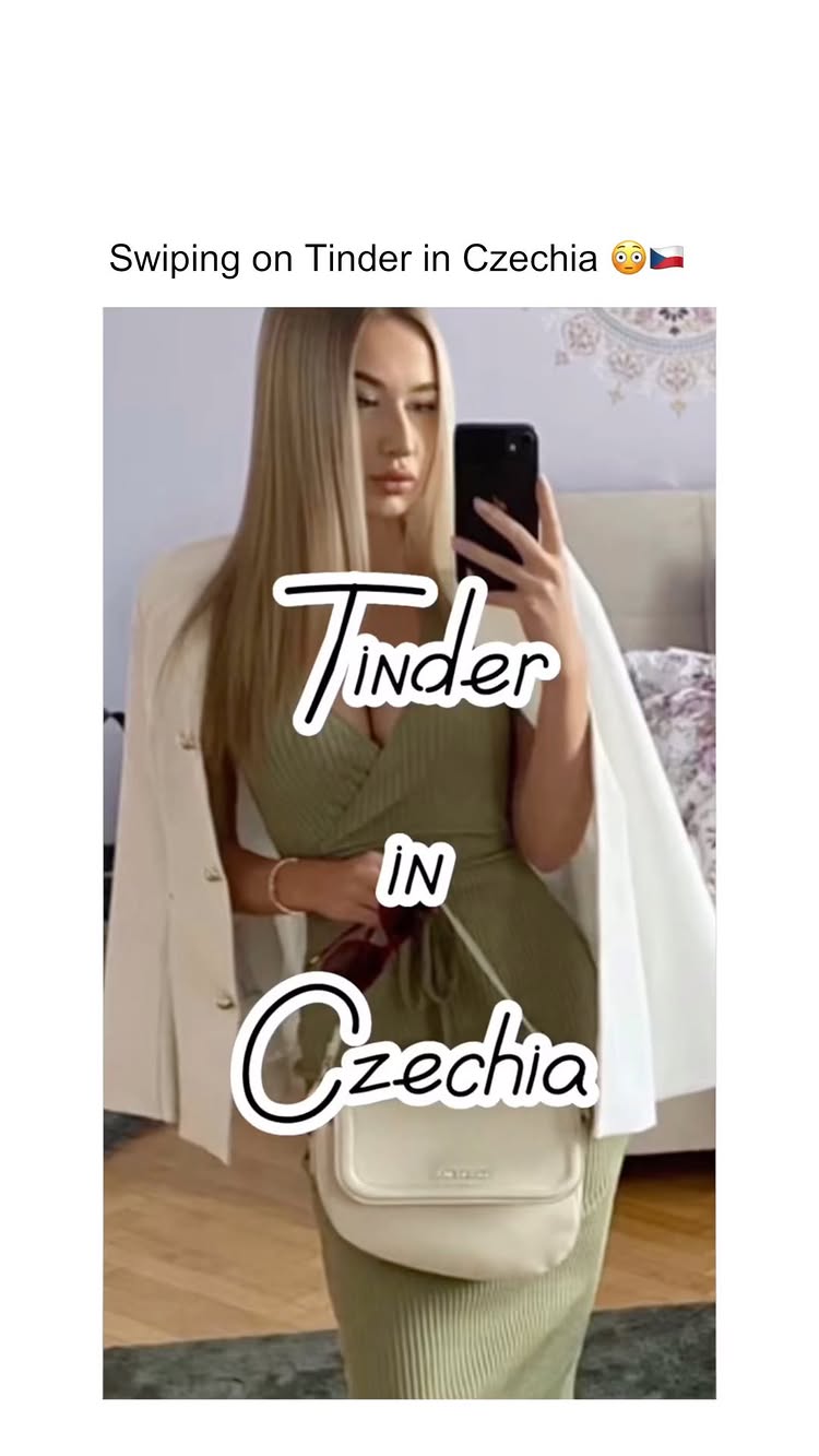 A woman is taking a selfie while looking at the camera. She is wearing a white blazer over a green dress and holding a phone in her right hand. The image has text overlayed in the image.
