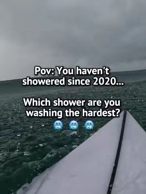 The image shows a shot from an elevated perspective of a white object jutting out of a body of greenish-blue water. Above this, the sky is a flat grey. Text is overlaid on the image in white, asking the viewer to consider which shower they would choose to wash the hardest, given they haven't showered since 2020. Three blue sweatdrop emojis appear below the text.