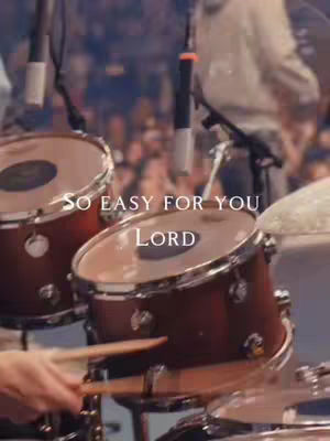 The image showcases a drum set on stage. Two drums are prominently displayed in the foreground, with the drum heads visible. The text overlay enhances the composition.