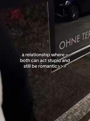 A nighttime shot with text overlayed on a street scene showing a vehicle and a sign that says OHNE TER.