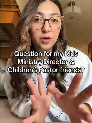 A woman with long, wavy brown hair and glasses looks towards the camera with a slightly open mouth. Text overlayed on the image asks a question related to the video's topic. The background is a softly lit interior.