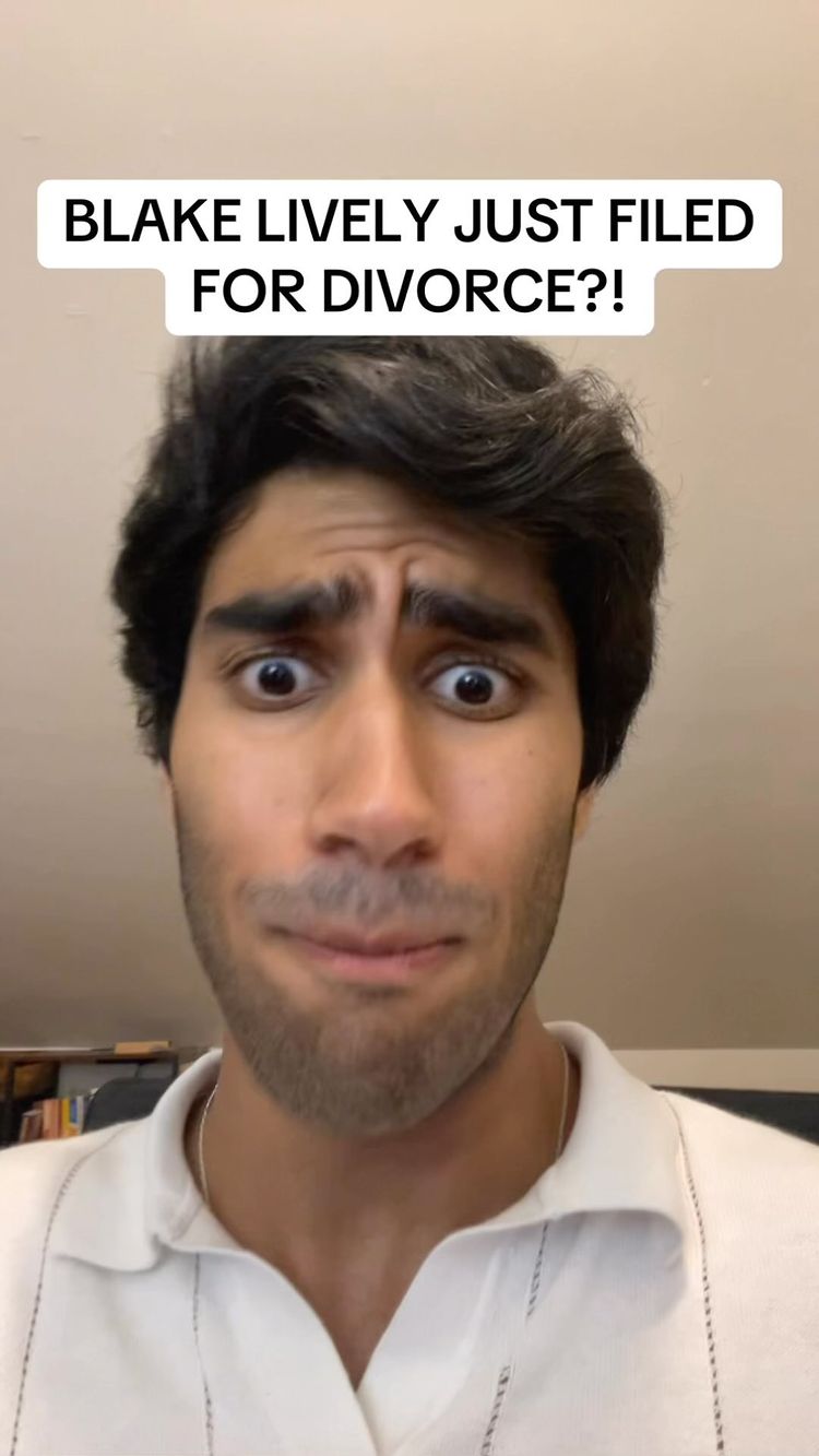 A selfie-style shot featuring a young man with dark hair, furrowed eyebrows, and wide, surprised eyes. He has a slight smile and a partially visible white shirt. Above him is a white rectangular text box with the words 'BLAKE LIVELY JUST FILED FOR DIVORCE?!' in black text.