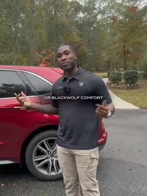 A man in a dark polo shirt and khaki pants stands angled, next to a red SUV, outside. The text overlay reads, "OR BLACKWOLF COMFORT."