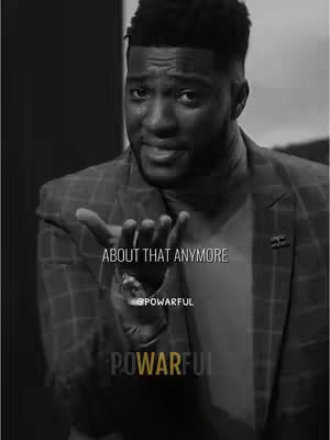 The cover image is a monochrome shot of a Black man in a suit jacket, with a focus on his face and hand gesture. The man is looking at the viewer with a slight smile. The layout is simple, with overlaid text at the bottom.