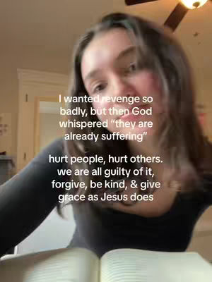 A selfie-style shot featuring a young woman gazing toward the camera, with text overlays. The background is blurred, with light-colored walls and a hint of a ceiling fan.