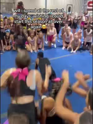 The image shows a group of cheerleaders gathered in a circle on a blue mat. In the foreground and background, they are in various poses, and one is mid-tumbling. Text is added to the cover image.
