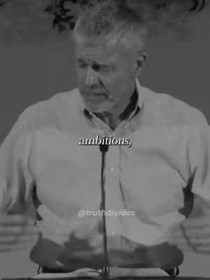 A grayscale image features a man giving a speech. He is positioned from the chest up, with a microphone in front of him. The background appears to be a stage or similar setting. Text is overlaid on image, with the creator’s handle at the bottom.