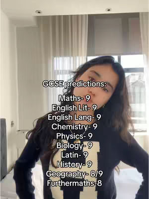 A young woman with long dark hair is centered against a neutral background. Above her head, white text overlays the image, listing subject names and grades. She's wearing a black shirt and looking slightly towards the camera.