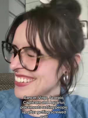 A woman with glasses and a bun smiles. Text overlays on the image.