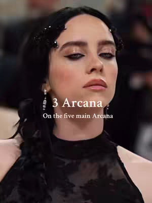 The image is a close-up of a person, likely a celebrity, against a blurred background. The person has dark hair and is wearing black attire and elegant earrings. Text overlays appear on the image including "3 Arcana" and "On the five main Arcana". The overall composition is stylish with a focus on the person's face.