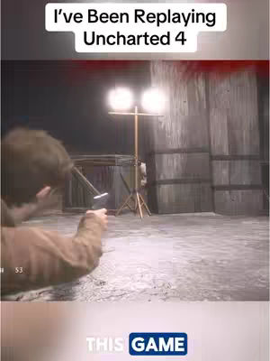 The image shows a scene from a video game. In the background, there is a wooden wall and a light fixture. In the foreground, a man is pointing a gun.