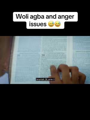 The image displays an open book with text, a hand pointing at the text, and a text overlay at the top. The book is open to a page with lines of text. A hand with visible fingers is pointing at the book. The text overlay reads, \"Woli agba and anger issues π
π.\"