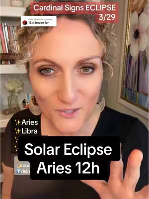A woman with curly blonde hair is shown from the chest up, centered in the frame. She is looking directly at the camera and speaking. A black text box at the bottom says Solar Eclipse Aries 12h. The background is a room with a blurred image of flowers on the right and a bookshelf on the left.