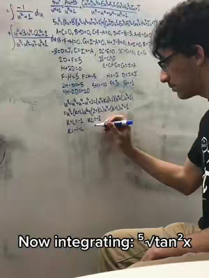 A man with glasses is writing mathematical equations on a whiteboard, while looking towards the right as the lower portion of the image displays the text overlayed.