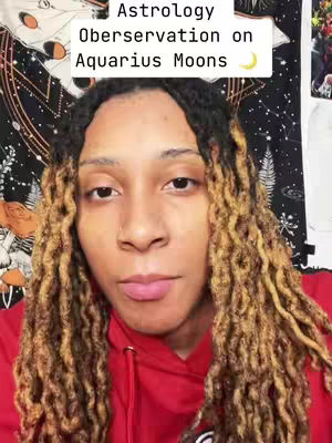 A close-up selfie featuring a person with long, light-brown dreadlocks and a red hoodie. The background includes a patterned tapestry and a blurred image. The top of the image contains text overlay.