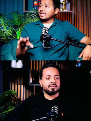 The cover image is a split composition featuring two distinct shots of a man. In the upper half, he is seated in a chair and is speaking into a microphone. The background includes an artificial plant. The lower half reprises the same man, but at a different angle, speaking in a black shirt. Microphones are featured in both halves. The whole has a feel of video podcasting or creating general commentary.