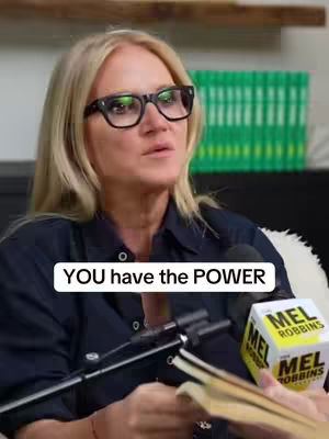 A woman with blonde hair and glasses is speaking, holding a microphone, with the overlaid text 'YOU have the POWER' in a white rectangle. Behind her are stacks of green books.