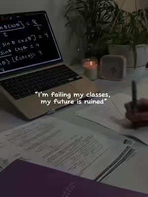 A dimly lit desk setup with a laptop displaying math equations, papers, a candle, and a clock. The image has a moody, studious aesthetic.