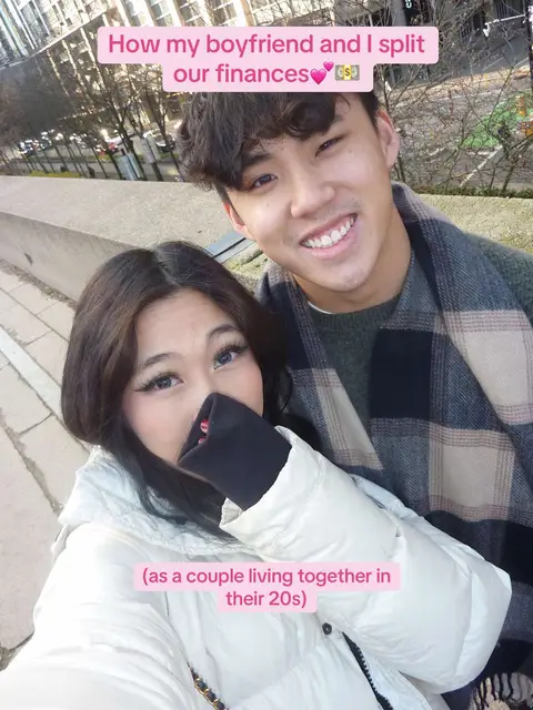 A selfie of a couple close together, with the woman in the foreground covering her lower face with her hand. The man in the back smiles directly at the camera. Text overlays are placed to the top and bottom of the frame.