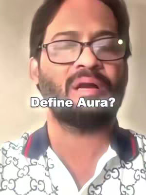 A close-up shot of a man with glasses and a beard, wearing a patterned shirt, with text overlayed.