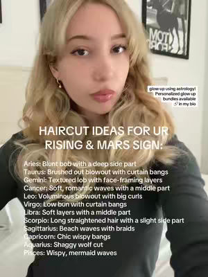 A selfie-style shot of a woman with light-colored wavy hair. She's looking directly at the camera with a soft expression. The background is blurred, including framed artwork and a glimpse of a bed. Text overlays provide information about hairstyles corresponding to astrological signs.