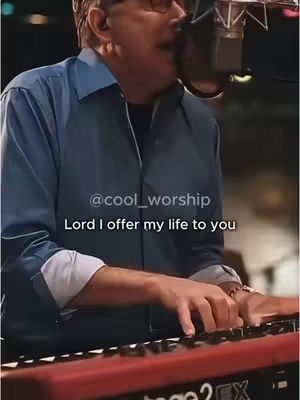 The cover image shows a man with glasses playing a keyboard and singing into a microphone. Text overlayed on the image reads '@cool_worship' and 'Lord I offer my life to you'. The man is wearing a blue shirt. The scene appears to be a musical performance or recording session.