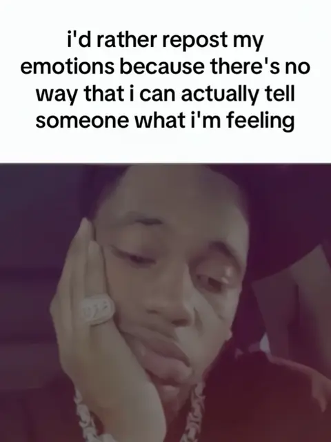 A selfie-style shot featuring an individual of color, with a somber expression. The individual is holding their hand to their face, with the elbow resting on something, suggesting introspection or contemplation. The lighting appears soft with a gradient, and the individual is wearing what seems to be a detailed chain. Text is overlaid, conveying a sentiment of emotional difficulty.