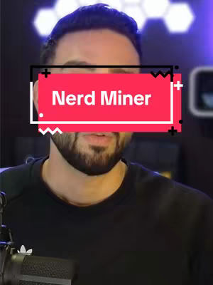 A medium shot of a man with short, dark hair and a neatly trimmed beard. A rectangular text overlay reading "Nerd Miner" covers his eyes. He is wearing a black t-shirt, and a microphone obscures the bottom-left.
