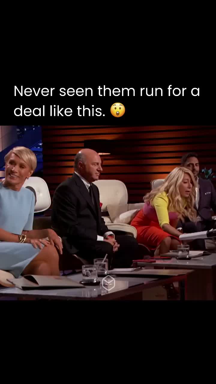 The cover image captures a scene from the television show "Shark Tank". The image features several of the show's investors seated at a table. The central focus is on Kevin O'Leary, with Lori Greiner and another woman partially visible to his left. Behind them is a wooden wall setting. The lighting appears to be from studio lights.