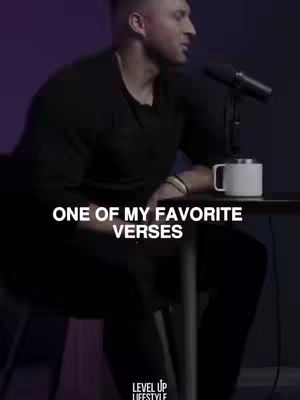 A man is seated, speaking into a microphone. The cover image is dimly lit, and the background is a gradient of colors. Text overlaying the image reads "ONE OF MY FAVORITE VERSES". A white mug sits on a table next to the man.