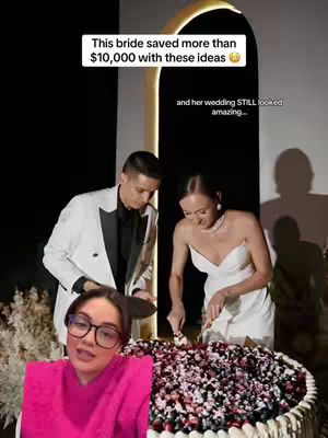 The cover image shows three main elements: a bride and groom cutting a multi-layered cake, a woman with glasses in the lower left corner talking to the camera, and text at the top about saving money on a wedding. The cake is the focal point, covered in berries, while the background silhouettes are of guests. The woman in the pink shirt in glasses looks like she is hosting.