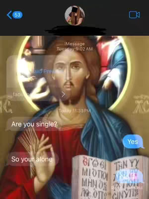 The image features a digitally altered depiction of Jesus Christ positioned as though interacting within a phone messaging app. The central figure is a classical rendering of Christ with long hair, a beard and wearing a red robe and blue mantle, set within a golden halo. Simulated text bubbles from a mock messaging app, with the question, "Are you single?" followed by "Yes" and "So your alone", overlay the image, simulating a dialogue. At the top, icons representative of a phone messaging interface and the blurred out profile picture reinforces the theme. The overall composition mixes religious iconography with the modern messaging context.