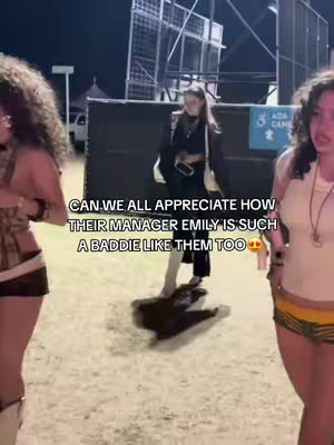 Three young women are posing outdoors at a festival, likely Coachella, based on the caption's hashtags. The image is a selfie-style shot with the subjects close to the camera. Text overlay at the bottom. The woman on the left has curly hair and is wearing a top of brown tones. The woman in the middle is wearing black and white clothing. The woman on the right is wearing a white top and cut off shorts.