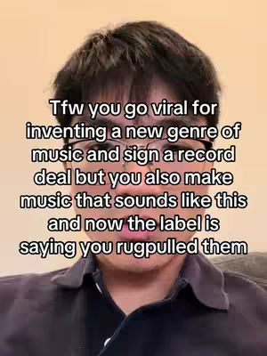A selfie-style shot of a young man with dark hair and glasses, centered on his face and upper chest. The background is a plain, light-colored wall. Overlaying the image is white text describing a scenario where someone went viral for inventing a music genre, signed a record deal, but is now being criticized because the music sounds different.