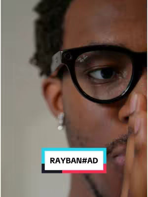 The cover image features a close-up of a man wearing dark-framed glasses with the Ray-Ban logo visible. His eye is in focus, and part of his face is obscured by his hand. Overlay text in a colored box reads 'RAYBAN#AD.' The background is a neutral color.