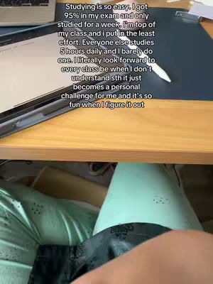 The cover image shows a person's legs and arms in a casual setting, likely indoors. The upper body is partially visible, resting against a table with a laptop and a tablet. Text is overlaid on the image, providing study-related motivation. The lighting is bright, and the composition is straightforward, focusing on the workspace and the person's relaxed posture.