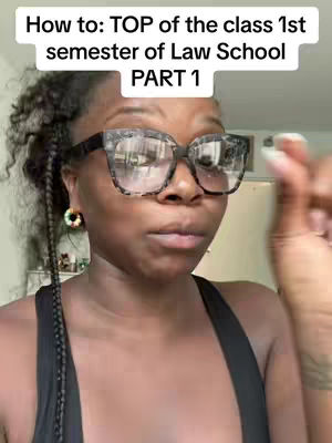 A woman with glasses is centered in the frame. The background is slightly blurred, suggesting an indoor setting. Text overlays at the top provide context. The woman is wearing large, square spectacles, with frames and is wearing an earring.