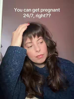 A woman with long wavy brown hair and a blue sweater is on the cover. She is looking down and to the right with her hand touching her head. A pink wall is behind her.