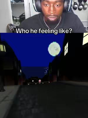 The cover image is split horizontally. The top half features a close-up of a Black man wearing headphones, with his mouth slightly open in a look of surprise or contemplation. The bottom half shows a stylized, cartoonish street scene at night under a dark blue sky with a large, pixelated moon. The scene is rendered in low detail, suggesting a video game or animated setting, with two long buildings and a character in the middle of the road.