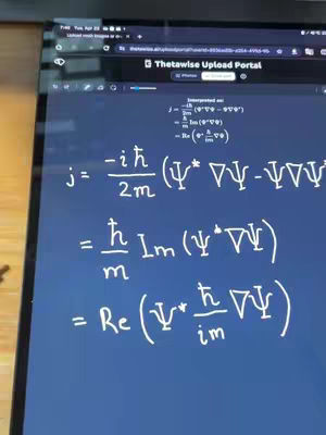 A close-up image of a laptop screen, displaying complex mathematical formulas and equations written in white against a dark blue background. The screen is tilted, and part of a desk or table is visible in the foreground. The top left corner of the screen shows a web browser interface with the name “Thetawise Upload Portal”.