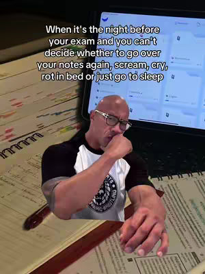 The image features a man, who resembles Dwayne 'The Rock' Johnson, sitting at a desk. In front of him is an open notebook and what looks like an open laptop or tablet. Text is overlaid on the top, and the man has a thoughtful expression, appearing to contemplate. The color scheme appears predominantly grayscale and blueish, setting a reflective, slightly melancholic tone.