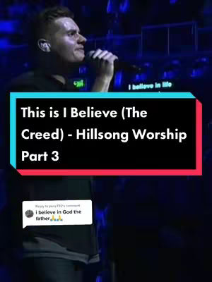 A man wearing a black shirt is singing into a microphone. Text overlays that is in a rectangle.