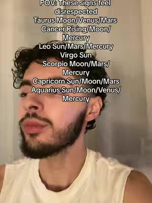 A medium shot features a young man with dark hair and a beard, positioned slightly off-center. Text overlays with astrological and personality details are superimposed over his head. The background is simple and out of focus, allowing the focus to remain on the man and the text.