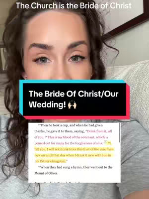 A woman with light skin tone is in a selfie shot, appearing to be in her home. She has brown curly hair and is wearing a grey top. The image includes a text overlay in a rectangular box, and a portion of a bible verse.