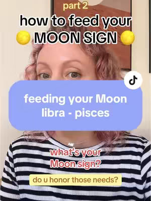 A woman with pink hair is positioned in front of a background image. Above her is text that reads 'part 2 how to feed your MOON SIGN'. A blue rectangular shape in front of her contains the text 'feeding your Moon libra - pisces'. Below that is a red text that reads 'what's your Moon sign?' with a yellow rectangle below the text that reads 'do u honor those needs?'.