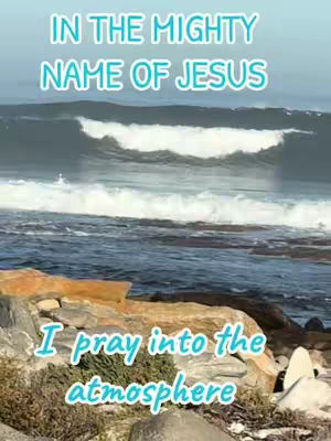 The image shows a scenic ocean view with waves crashing. Text overlays appear in a stylized font, emphasizing the religious theme with the phrases "IN THE MIGHTY NAME OF JESUS" and "I pray into the atmosphere."