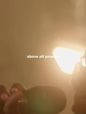 A warm-toned image features a bright, undefined light source, possibly the sun, casting a strong glow. The text overlay 'above all power' appears in white at the bottom center.
