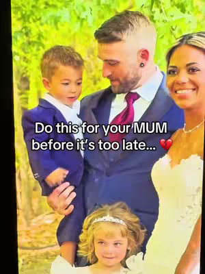 The cover image shows a family portrait at what appears to be a wedding. The main focus is on a man holding a young boy, both dressed in suits. A woman in a bridal gown is to the right, and a girl is in front of the man. The background is blurred trees, creating a soft, natural setting. Text overlay adds a message.