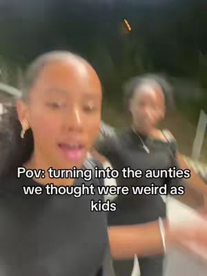 Two women are in the foreground, slightly out of focus. The main subject is facing the camera and talking, with a blurred background. Text at the bottom reads 'Pov: turning into the aunties we thought were weird as kids'. The color palette is desaturated but has natural tones.